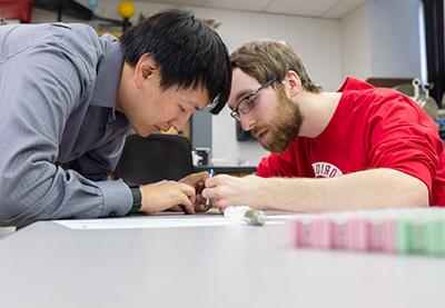 A student and teacher analyze data.